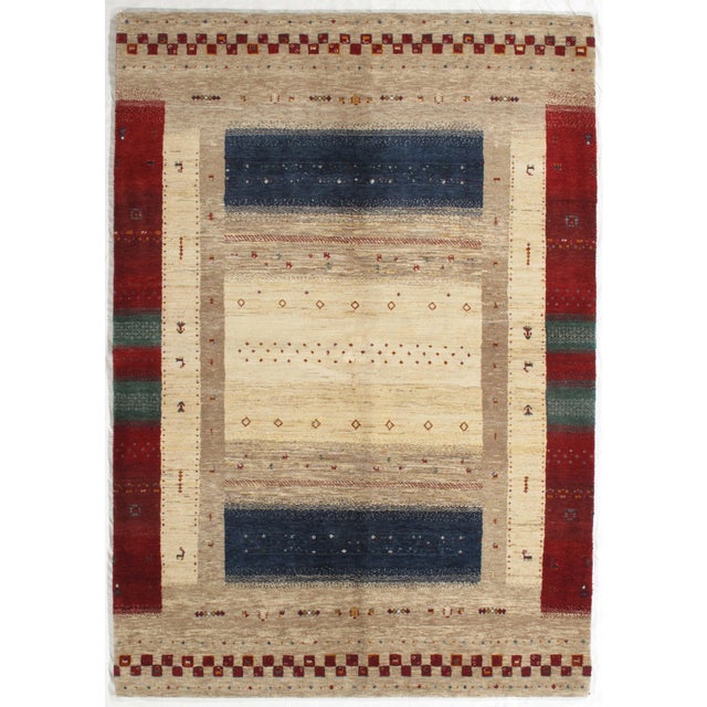 Vintage Hand-knotted Indo Gabbeh rug featuring a structured composition with a central field framed by bold side panels...