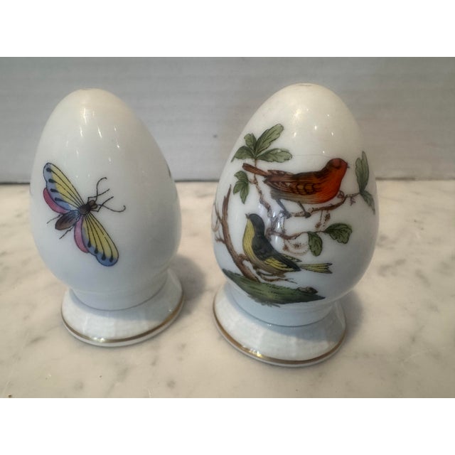 A vintage pair of Herend salt and peppers in the Rothschild Bird Pattern. Each unscrews from the base for filling.