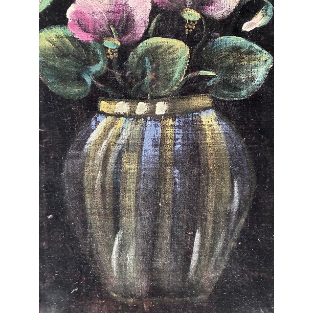 This vintage original painting is painted on velvet, showing pink flowers in a glass blue/yellow vase against a deep black...