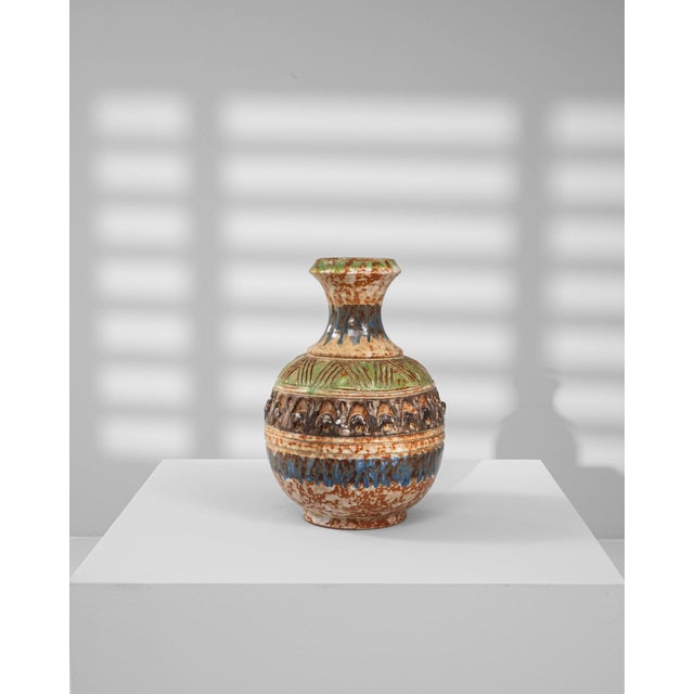 This 19th-century French ceramic vase showcases exceptional craftsmanship and rich decorative detail. Hand-thrown and...