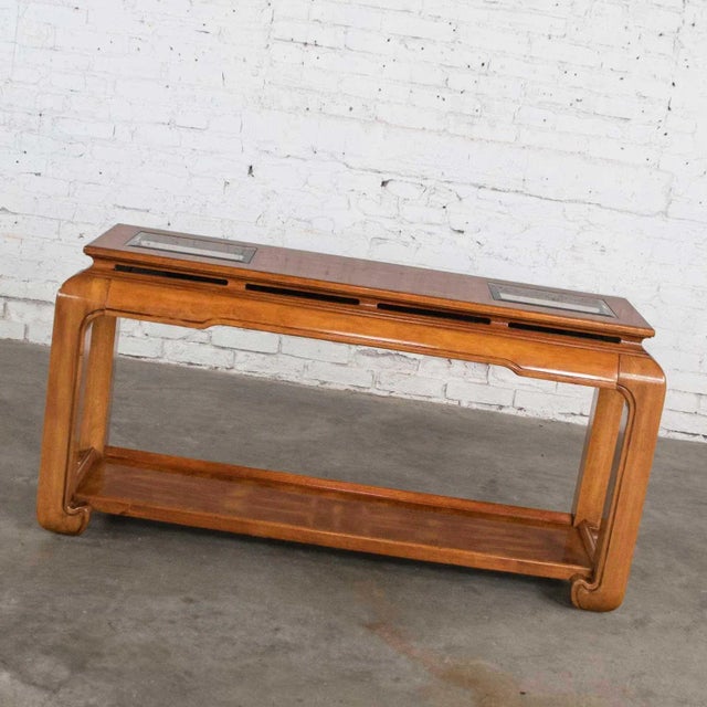 Stunning chinoiserie chow leg Ming style sofa table with two beveled smoke glass inserts and burl wood inlays. They are...