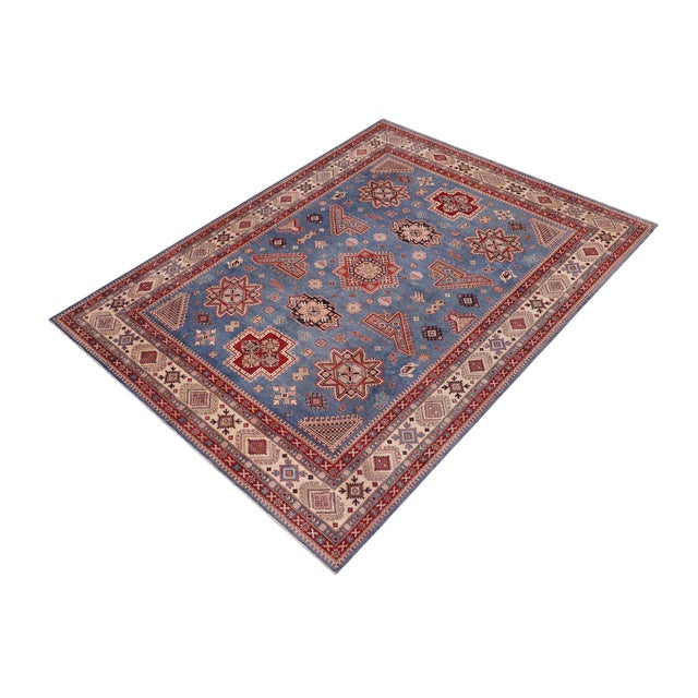 Enhance your home with this exquisite hand-knotted Kazak rug, crafted from fine hand-spun wool and dyed with all-natural...