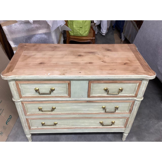 This French painted Louis XVI style chest of drawers is handsome and elegant. Made of Cherry, this piece was painted light...
