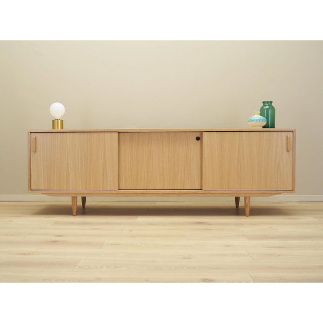 The sideboard was made in the Scandinavian style. The structure is covered with oak veneer. Lacquered surface. Legs made...