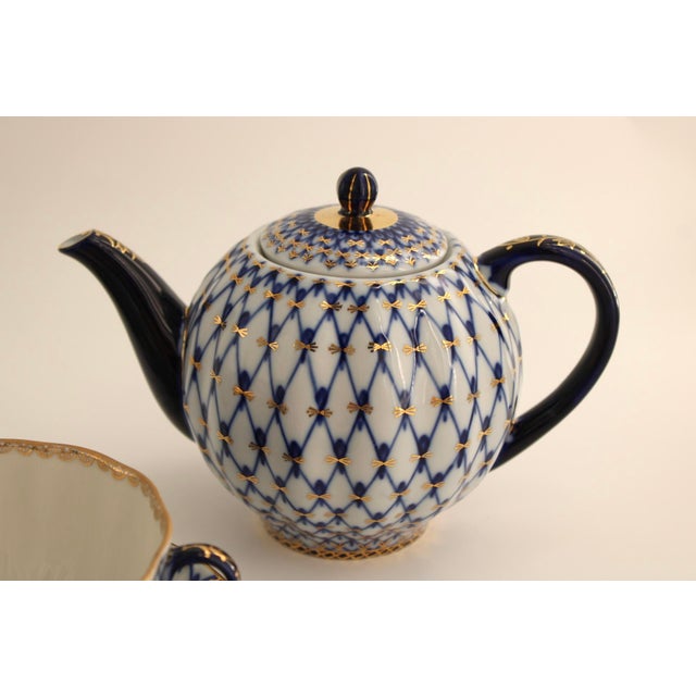 Authentic hand-painted porcelain tea set in the cobalt blue lattice weave pattern with 22 karat gold accents and rims....