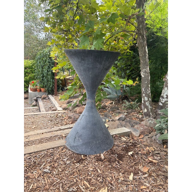 This planter is in the style of Willy Guhl and is made of cast iron. It is most likely reproduced and sold through Jayson...