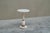 A beautiful side table in carved white and pink alabaster with elements in patinated brass. Italy, 1940s. This lovely side...