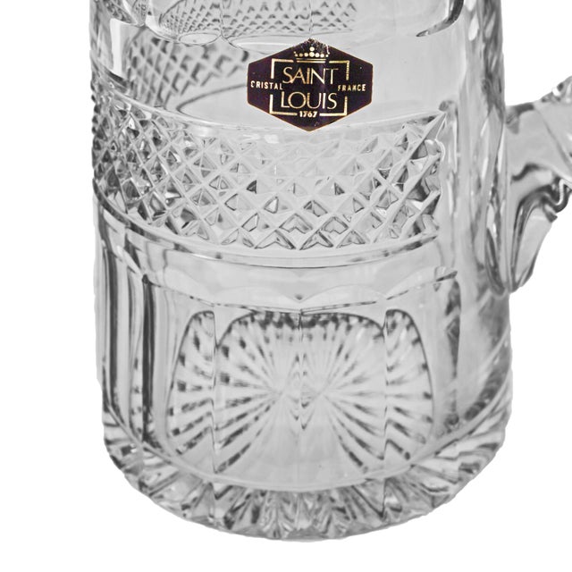 A tall, elegant French St Louis France crystal pitcher known as broc à orangeade, with a generously proportioned lower...