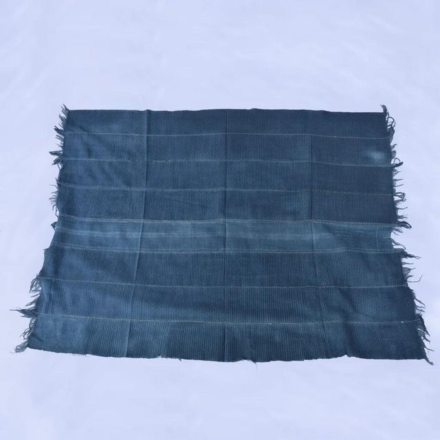 The cloth is made from Indigo resist-dyed cotton. This textile probably comes from the Dogon or Mossi people of Mali and...