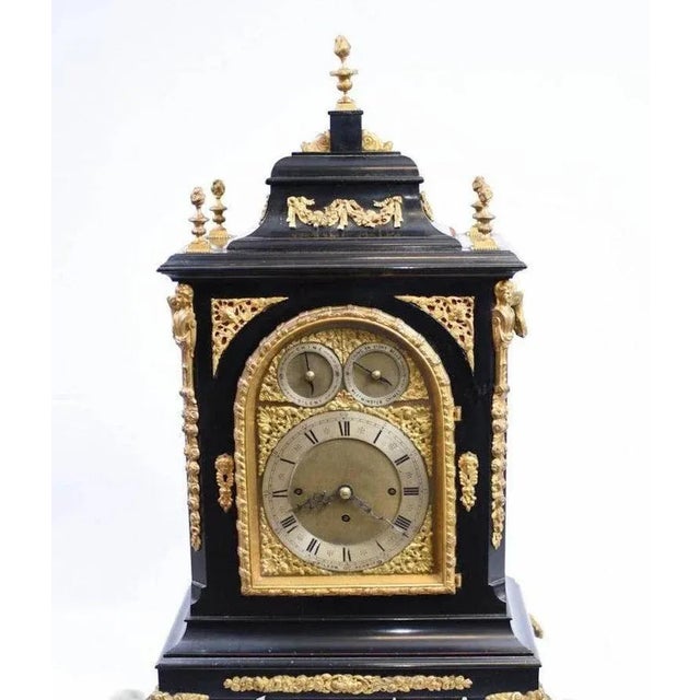 Victorian bracket clock, circa 1880 in an ebonised case with a silvered chapter ring displaying roman numerals with two...