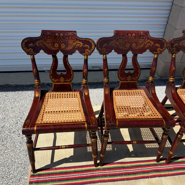 Antique Set of Four Federal Baltimore Style Paint Decorated Cane Seat Chairs, Circa 1820s A charming and decoratively...
