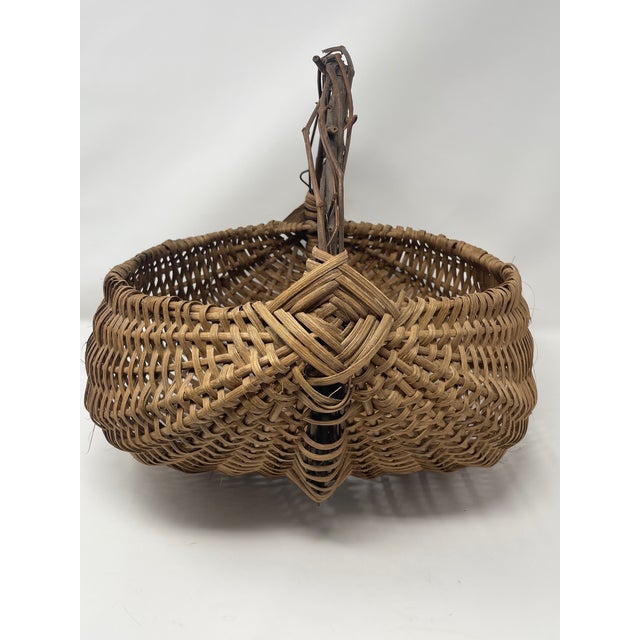 This exceptional antique buttocks basket (also known as a melon or egg basket) is a masterclass in American primitive folk...