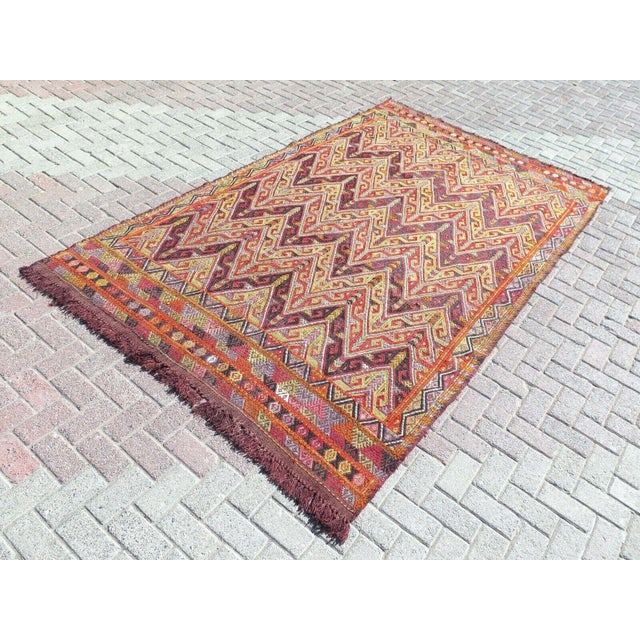 This beautiful, traditional vintage, flatweaved Turkish kilim rug is approximately 60 years old. It is handmade of very...