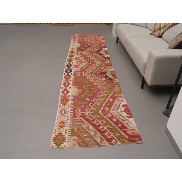 Vintage Hand-Knotted runner rug is a semi-antique vintage area rug. The '70s Eastern region of Anatolia's unique rug is...