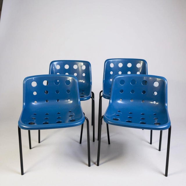 Robin Day Polo Chairs are a set of four royal blue mid-century dining chairs designed to bring classic British style and...
