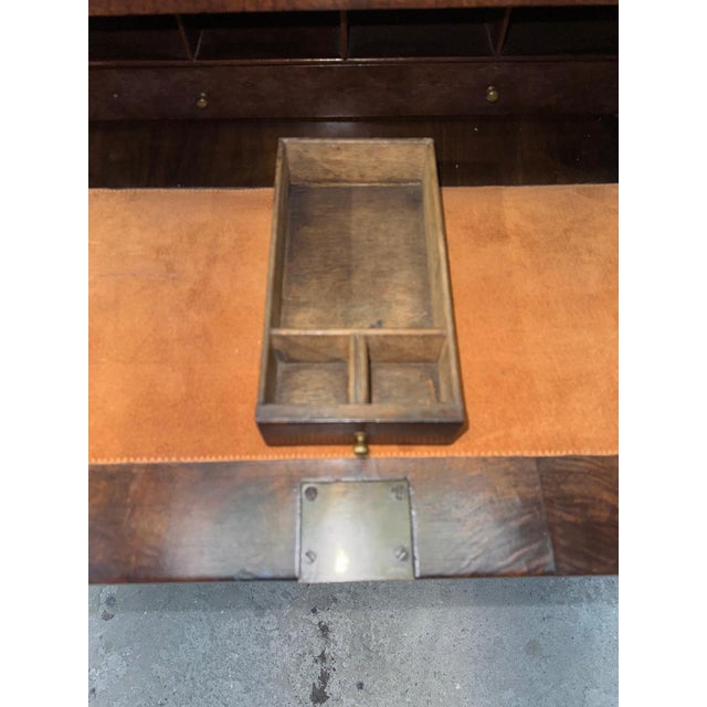 A fine English George III kneehole desk crafted in richly figured burl walnut, dating from the late 18th century. The...