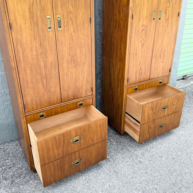 A handsome pair of vintage armoires from Drexel’s Passages collection, featuring warm walnut finishes and classic...