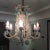 A wonderfully exuberant statement chandelier featuring an elaborate scrolling frame completely embellished with clear...
