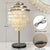 Elevate your home decor with this Modern Coastal Capiz Shell Tiered Table Lamp, a stunning statement piece blending...