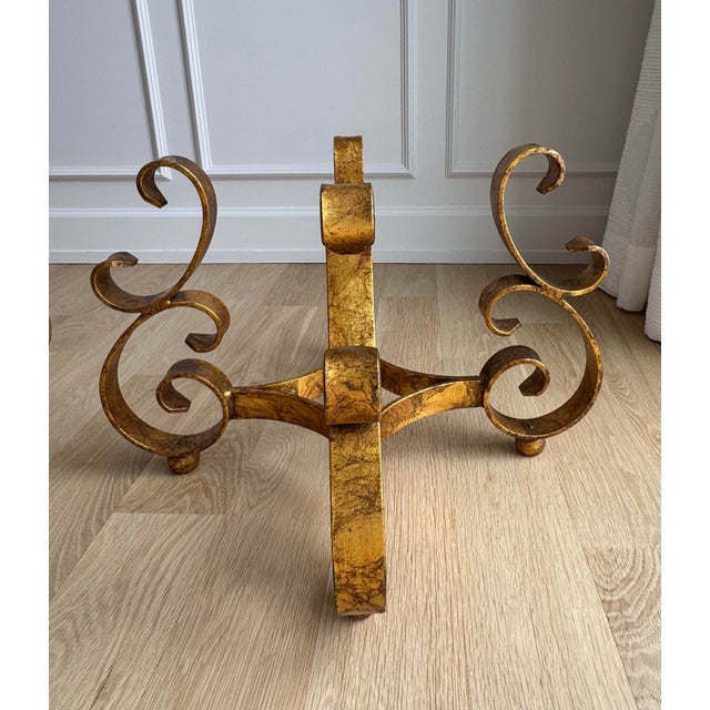 Striking matched pair of heavy, handcrafted wrought iron table bases featuring bold scrollwork and an original antiqued...