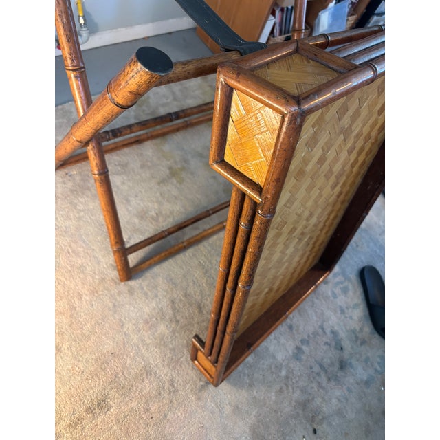 Lovely vintage folding tray table constructed with a faux bamboo frame and woven herringbone-patterned rattan surface....