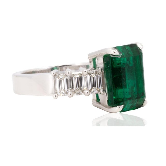 18k White gold ring with 4.85 carat top gem quality Zambian emerald and 6 colorless emerald cut diamonds weighing 1.18...