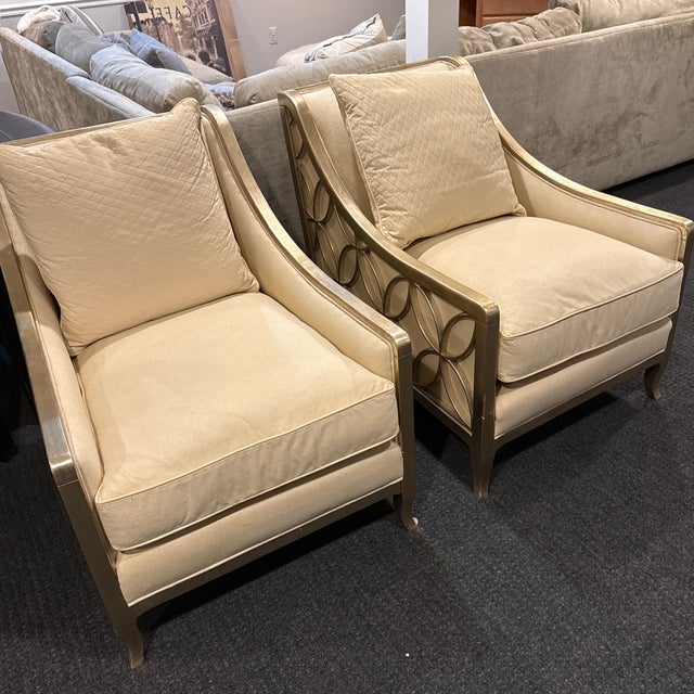 Two cream color, accent chairs Caracole gold leaf. Slightly used almost like new, few minor scratches $2000 a chair