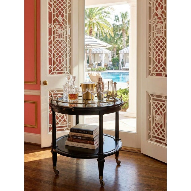 Hickory Chair Atelier Collection styled after 1940s French. This large and elegant round accent table or bar cart in a...