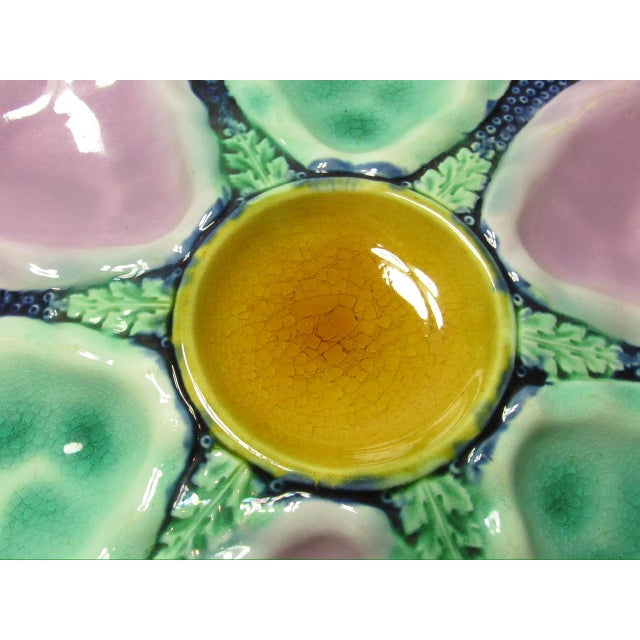 Antique English majolica oyster plate, c.1900 Featuring six shell shaped wells in turquoise and lilac around a central...