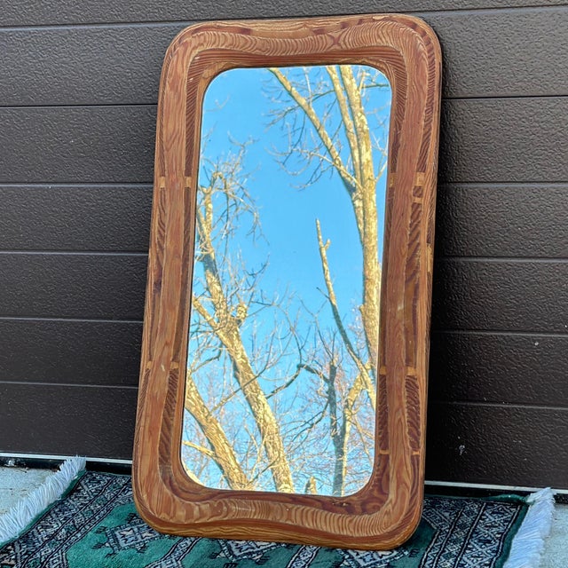 One of a kind decorative wall mirror featuring a hand crafted thick plywood frame which was sculpted to reveal various...