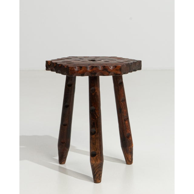 A 19th century French stool featuring a three-legged construction with carved wooden details. The form is compact, with a...