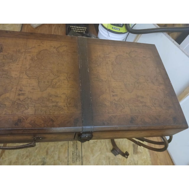World Map Suitcase console table Leather Straps & Buckles & wrought iron base A “suitcase” console table top depicting a...