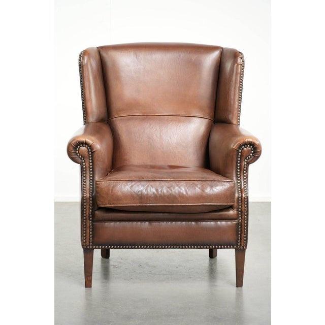 Beautiful dark brown sheepskin wing armchair with a timeless look in a subtle size. : This beautiful dark brown sheepskin...