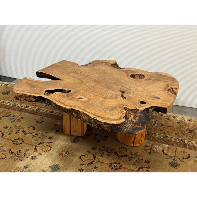 Design Plus Gallery presents a Live Edge Olive Wood Coffee Table. The table emphasizes natural grain patterns, organic...