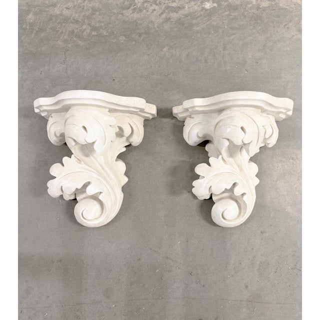 Stunning Rococo-Neoclassical cast-stone garden wall brackets. Wall brackets feature intricate scrolling leaves. Crafted...