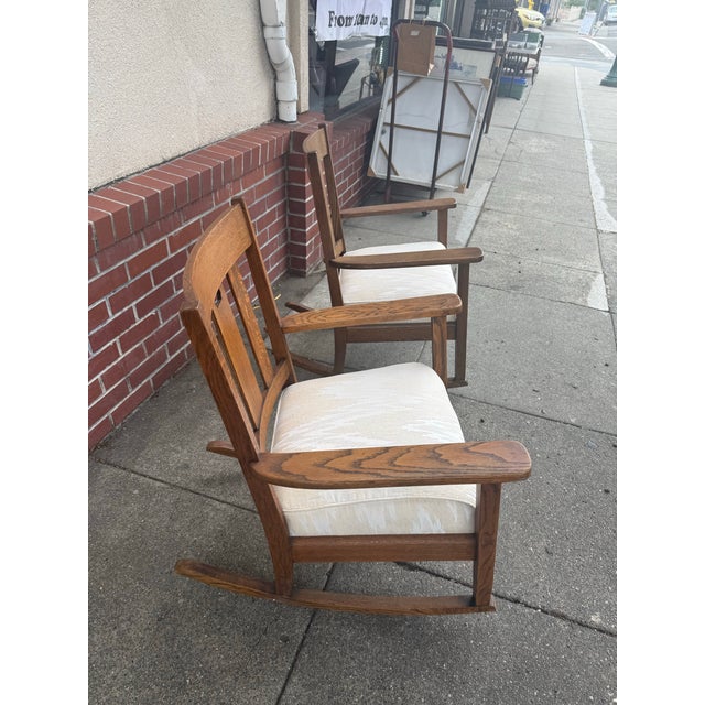 Rare find a pair of matched arts and crafts rockers with quarter sawn oak and padded cushion seats. The rockers are circa...