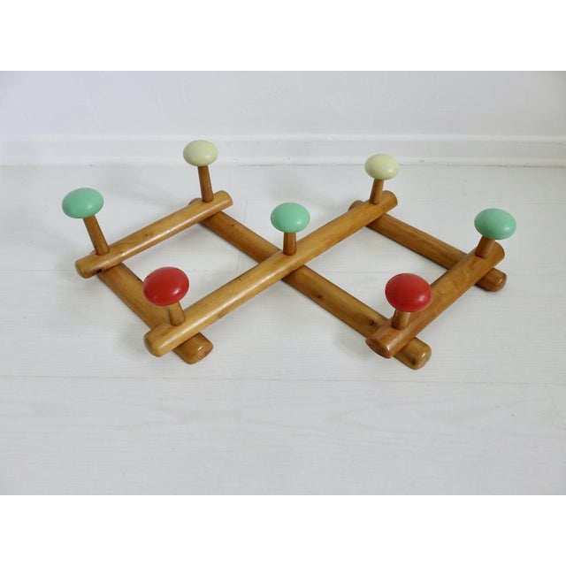 Accordion coat rack from the 1950s/60s Made in France Wooden frame 8 plastic hooks in yellow, green, and red Length 60 cm...
