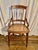 This Early 20th Century chair was crafted in France from walnut with a cane seat in the early 1900's. The chair features a...