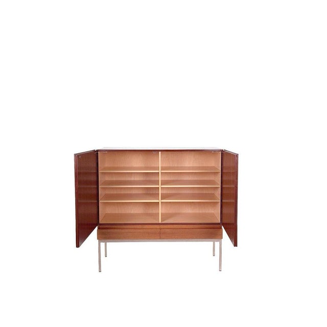 This mid-century teak highboard S21 was designed in the early 1950s by Dieter Waeckerlin and manufactured by Behr in...