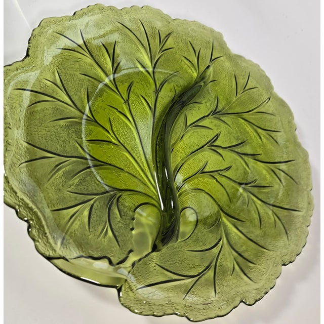 This vintage relish piece is made of intricately detailed pressed glass in the design of a leaf. The marriage of deeply...