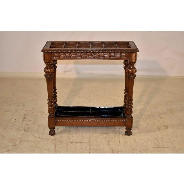 19th century oak umbrella stand from France with a beveled and carved decorated edge around the top, surrounding twelve...