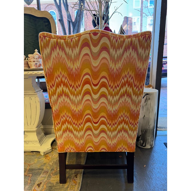 This is an antique mahogany Queen Anne lolling chair. It has a stunning designer fabric. The fabric is in a newer flame...