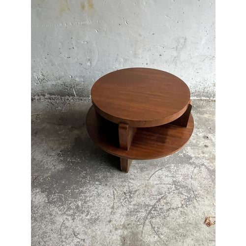 Introduction A sculptural vintage round coffee table with a strong architectural presence. The design features a solid...