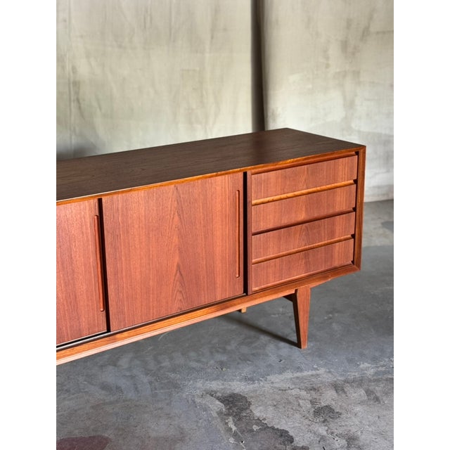 Elevate your interior with a rare and beautifully crafted example of Danish mid-century design — a lowline sideboard...