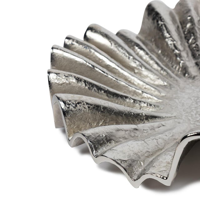 Not your grandma's lace doily. With a dramatic frill, our cast aluminum Soleil Metal Ruffle Plate adds a frisson of energy...