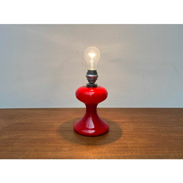 An early design by the renowned lighting designer Ingo Maurer from the late 1960s. This is a very rare version in red. An...