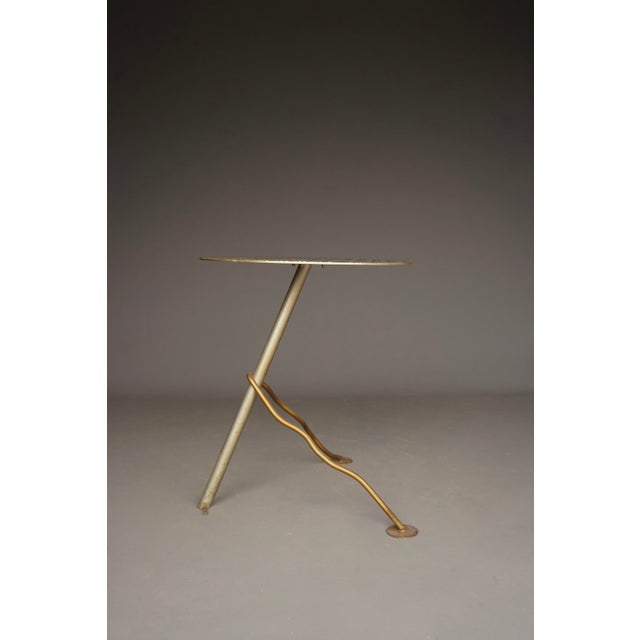 A striking and stylish side or garden table. Its simple metal structure that combines metal with different finishes is...