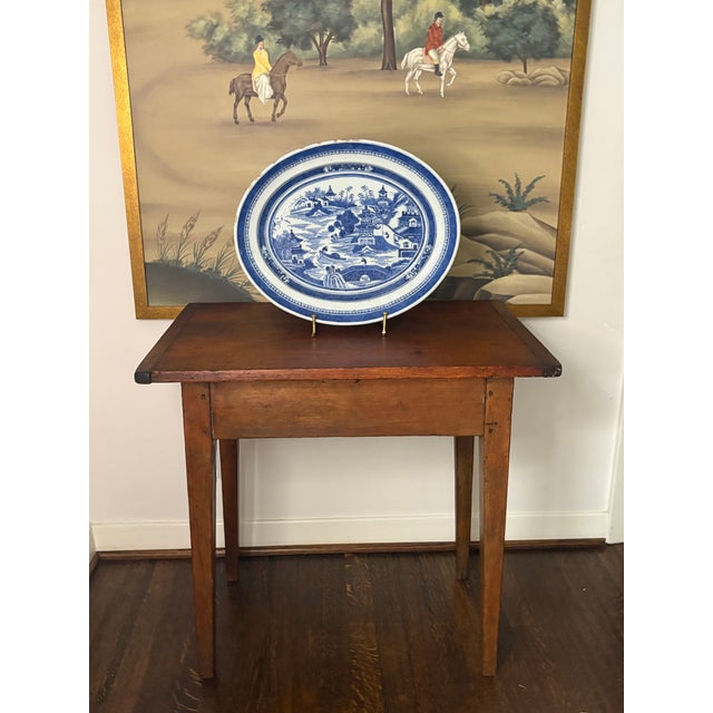 19th century New England side table with pine, breadboard top, hardwood base and square tapered legs. Traces of mustard...