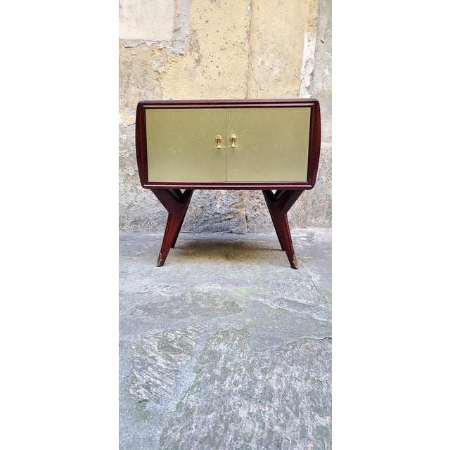 Two 1950s bedside tables of particular construction, walnut wood was used, doors covered in golden metal (a distinctive...