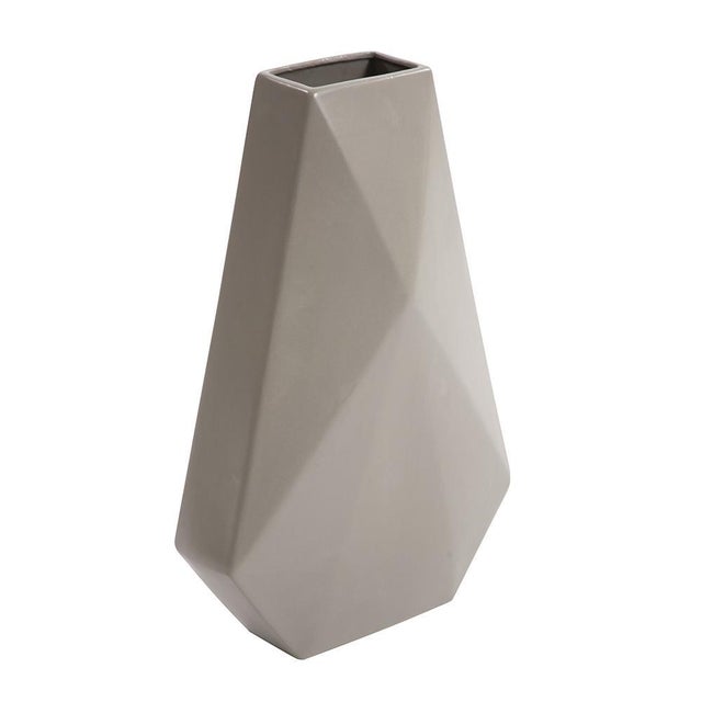 This ceramic vase features an interesting geometric styling that is enhanced by a matte stone finish exuding a soft,...